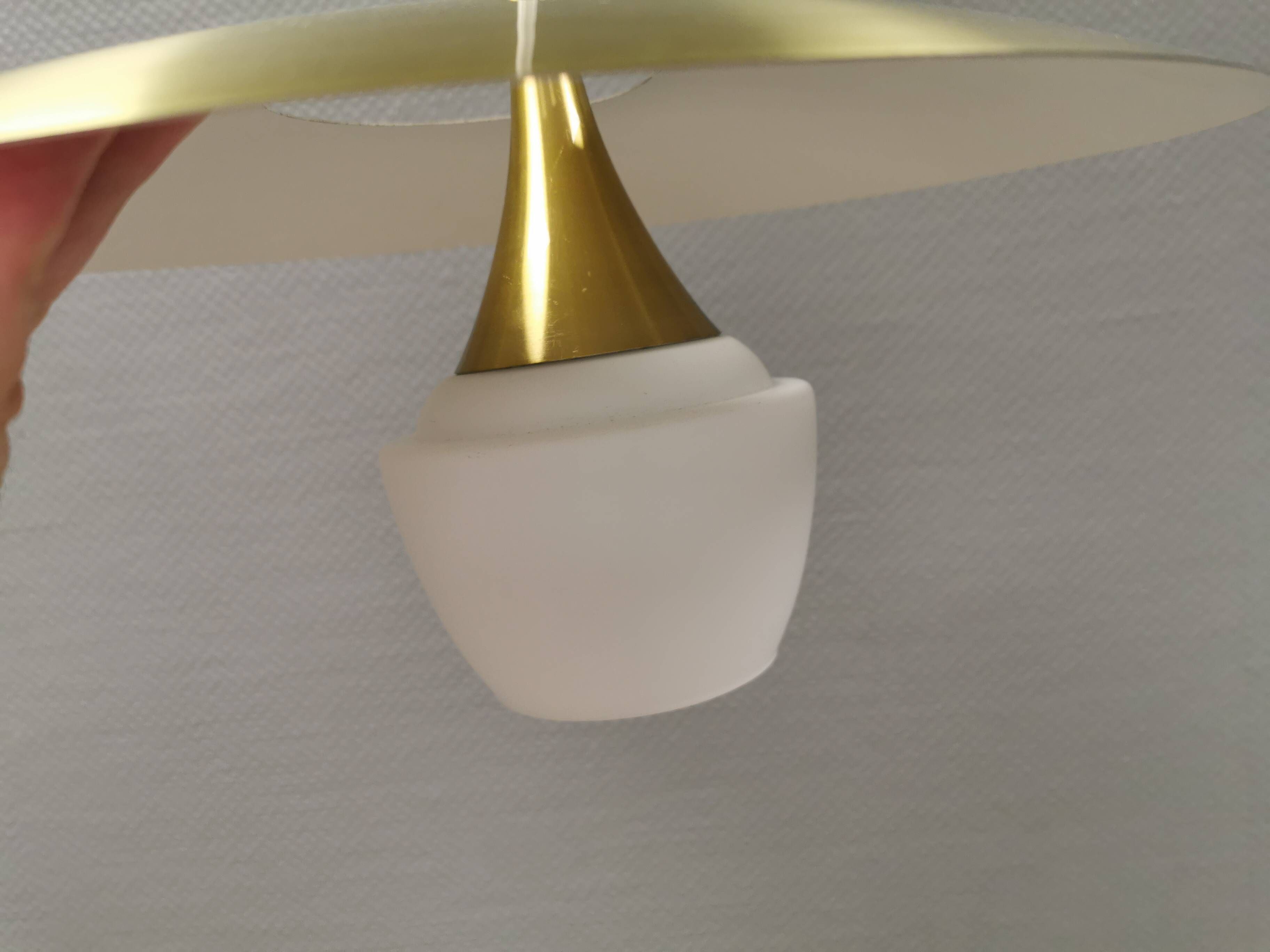 Hanging lamp, from the 1970s in matte white glass and brass colored metal.