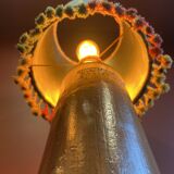 "Stoneware Bottle Lamp" with a multicoloured blue lampshade handwoven in India.