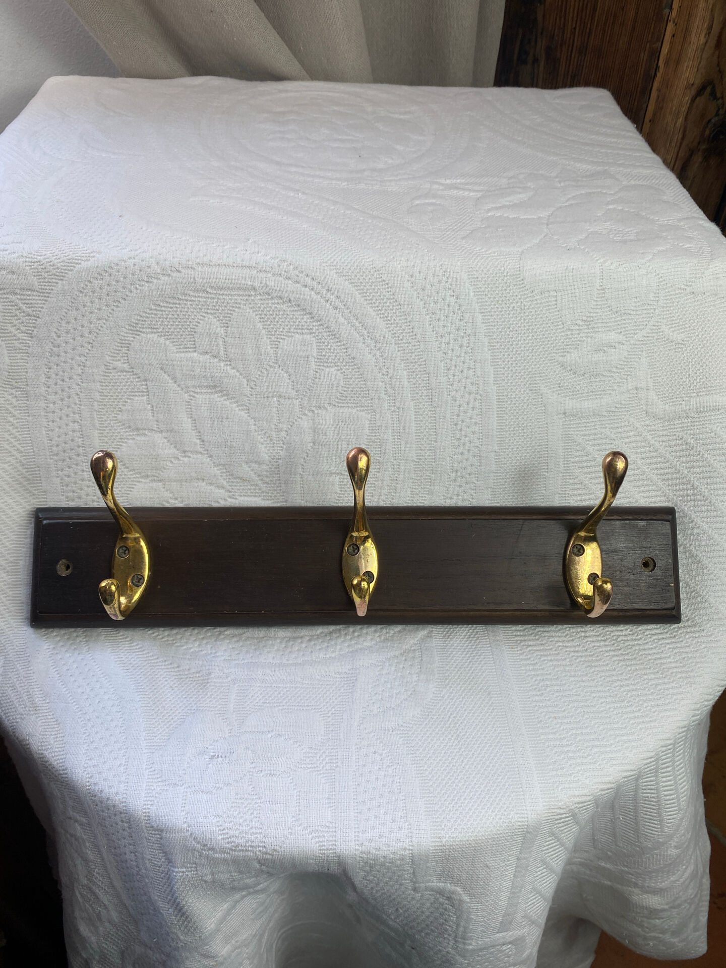 Wooden coat rack with double brass hooks