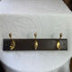 Wooden coat rack with double brass hooks