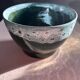 Green cache pot with a foam trim.