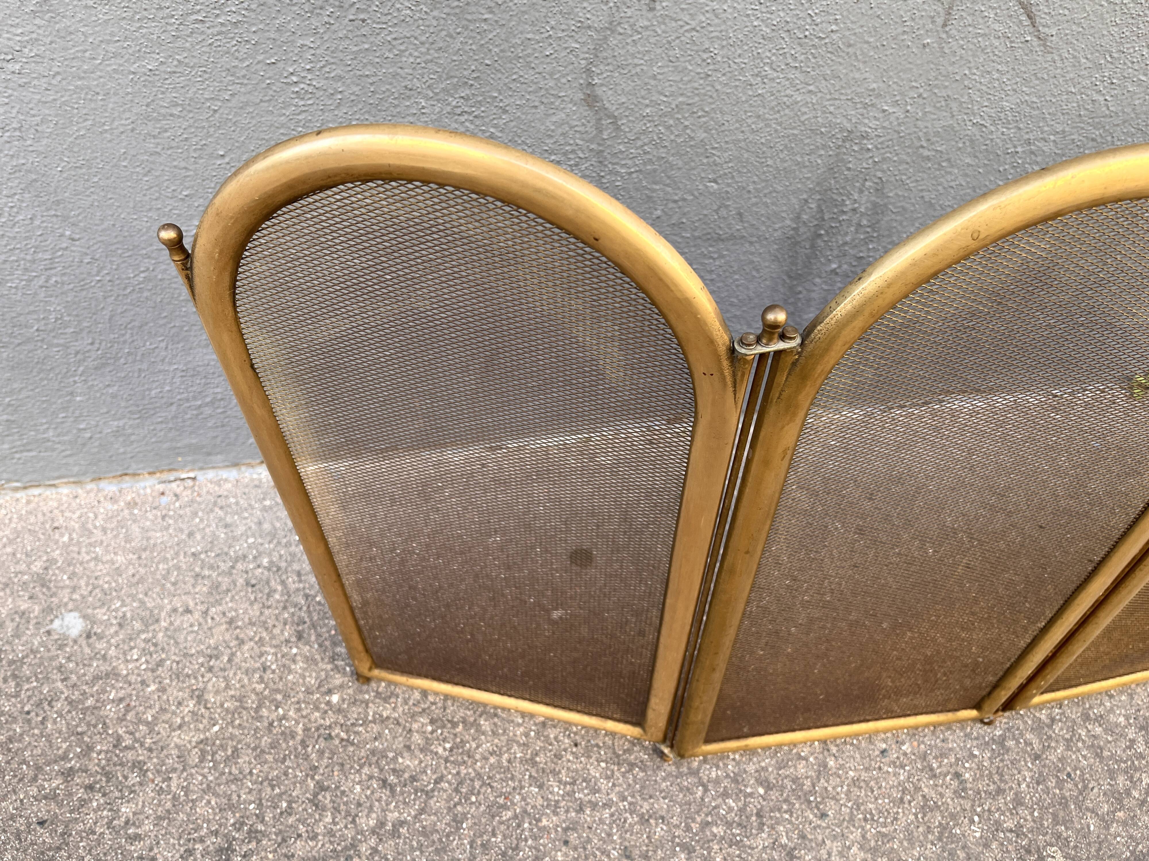 Antique brass fireplace screen from 1920, vintage spark guard.