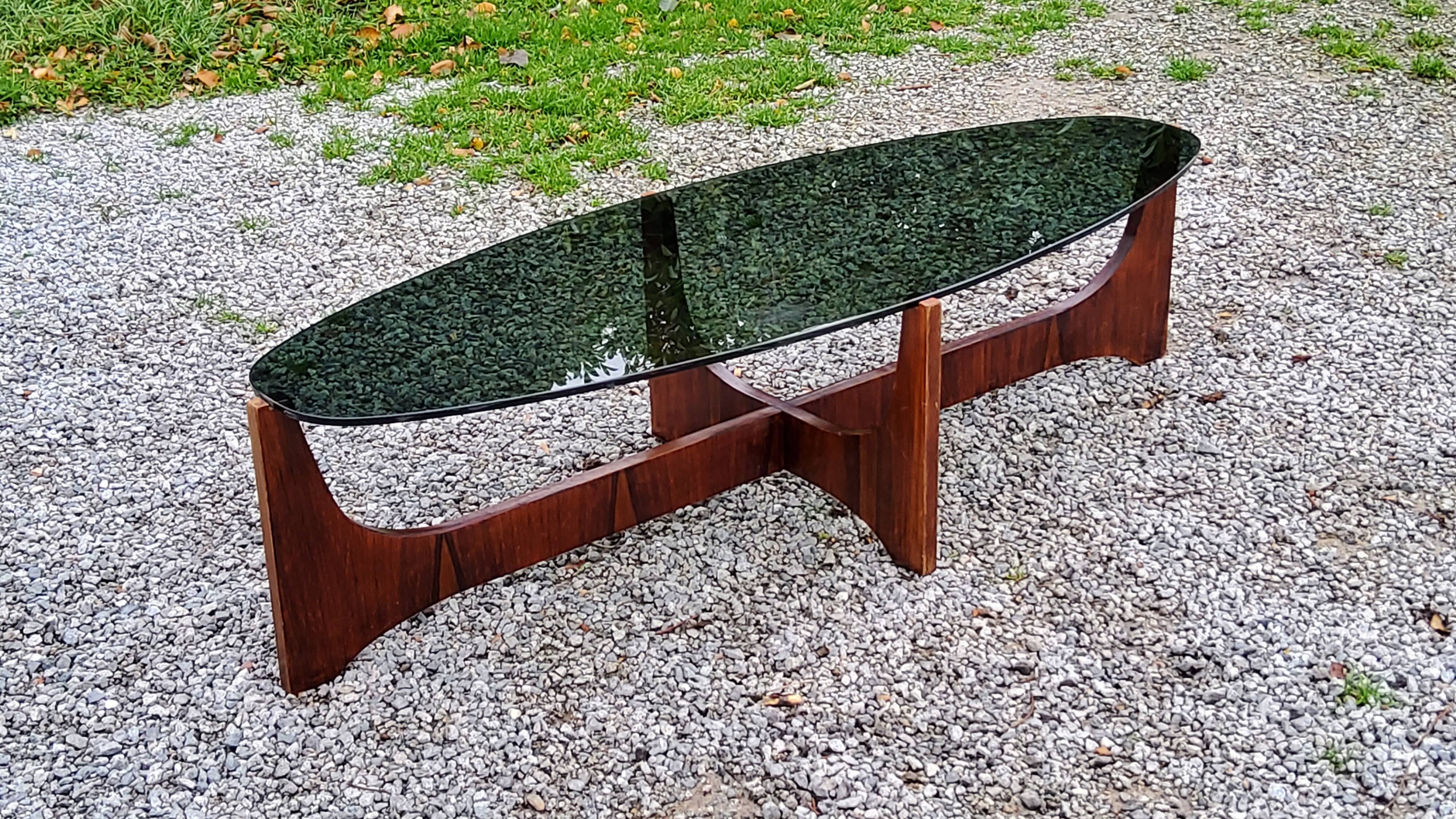 Designer coffee table by Hugues Poignant in rosewood and smoked glass from the 70s