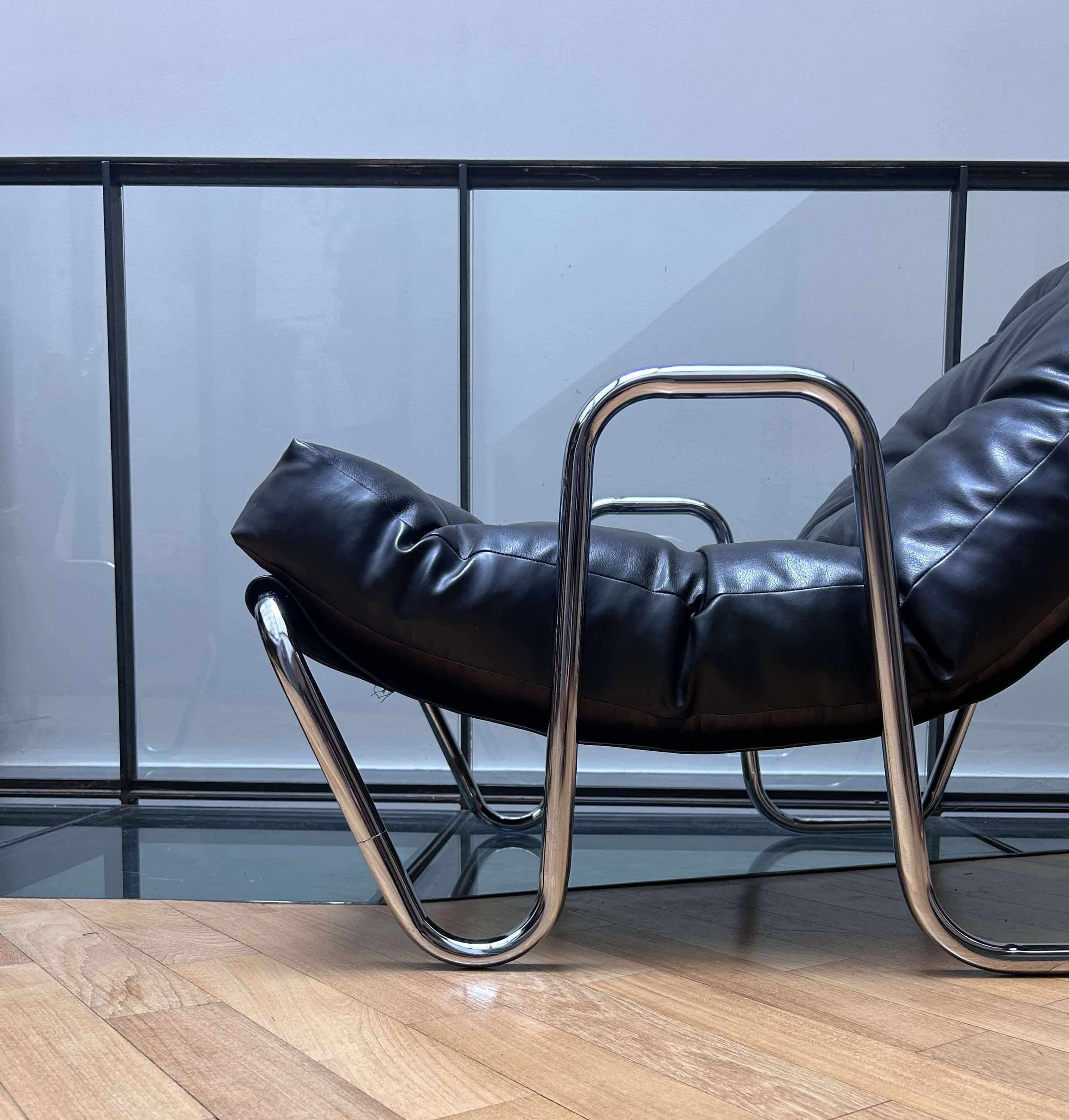 Pair of vintage armchairs in black imitation leather and chrome metal, France 1970