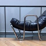 Pair of vintage armchairs in black imitation leather and chrome metal, France 1970