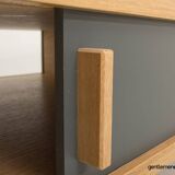 Table basse avec un caisson en chêne équipé de 2 portes coulissantes, pieds en chêne massif