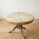 Round marble coffee table with a gold base in classic style.