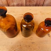 Trio of ancient apothecary bottles of beautiful amber color.