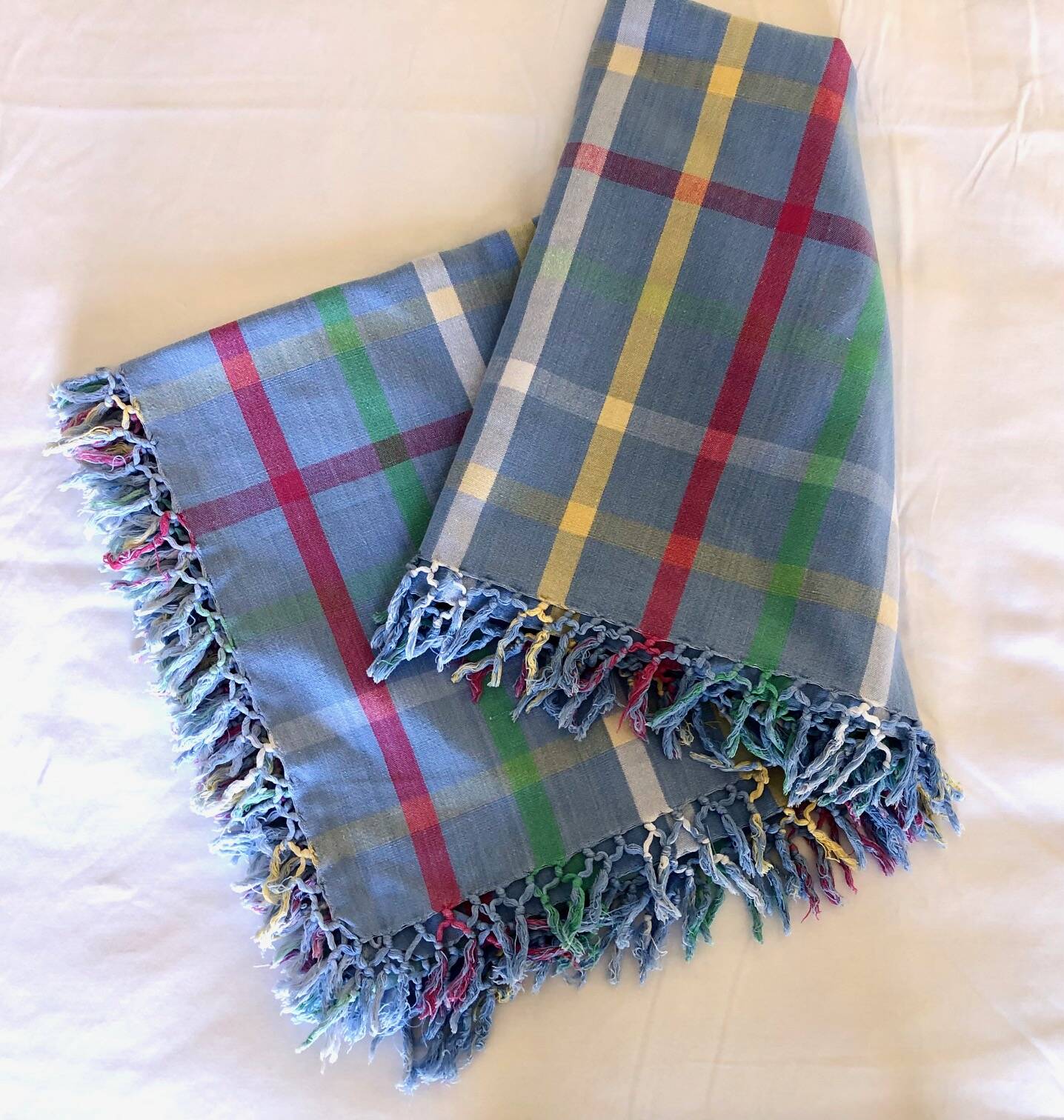 Vintage tablecloth & napkins, blue with multicoloured stripes.