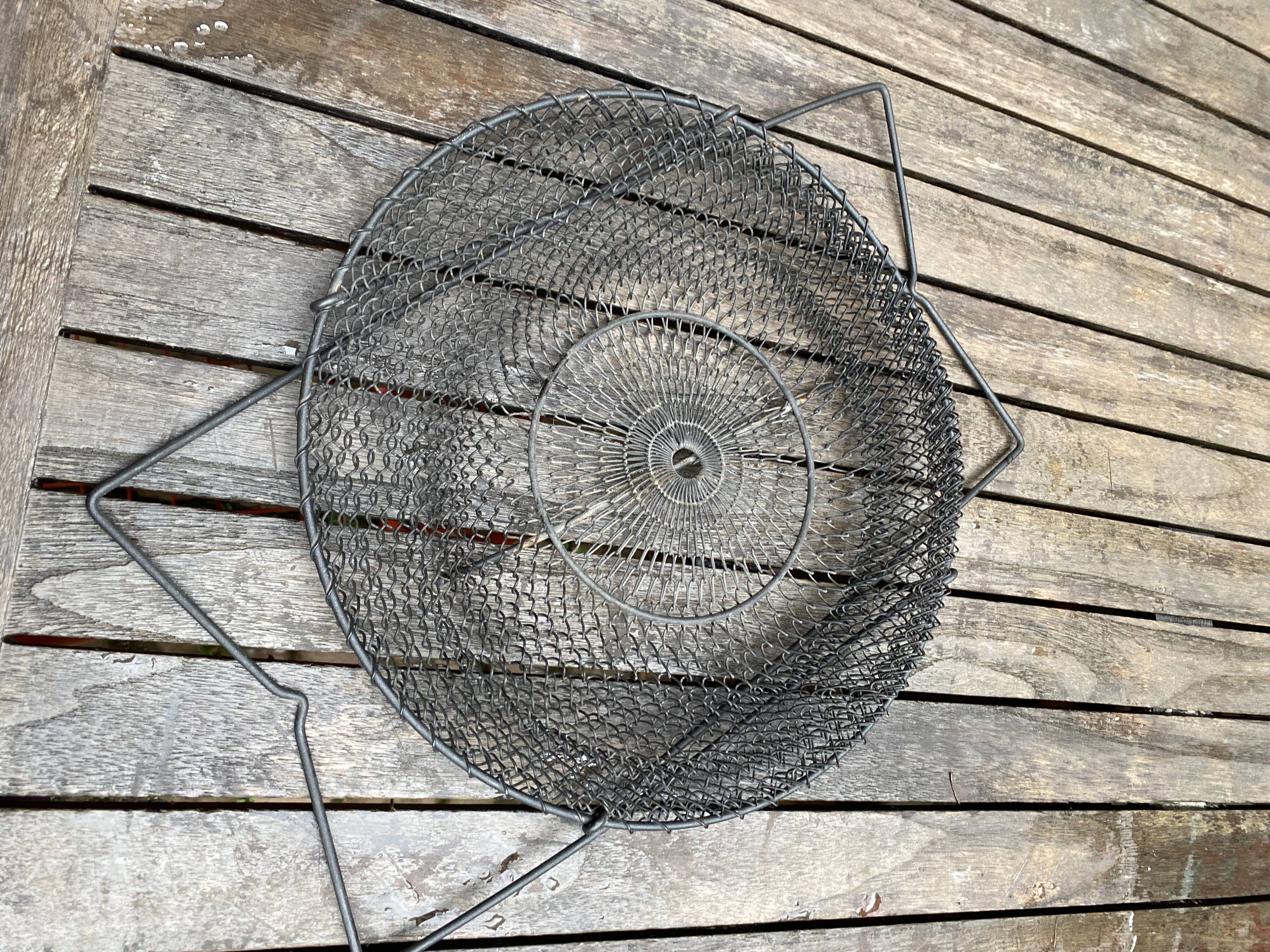 Foldable black woven metal wastepaper basket from around 1950.