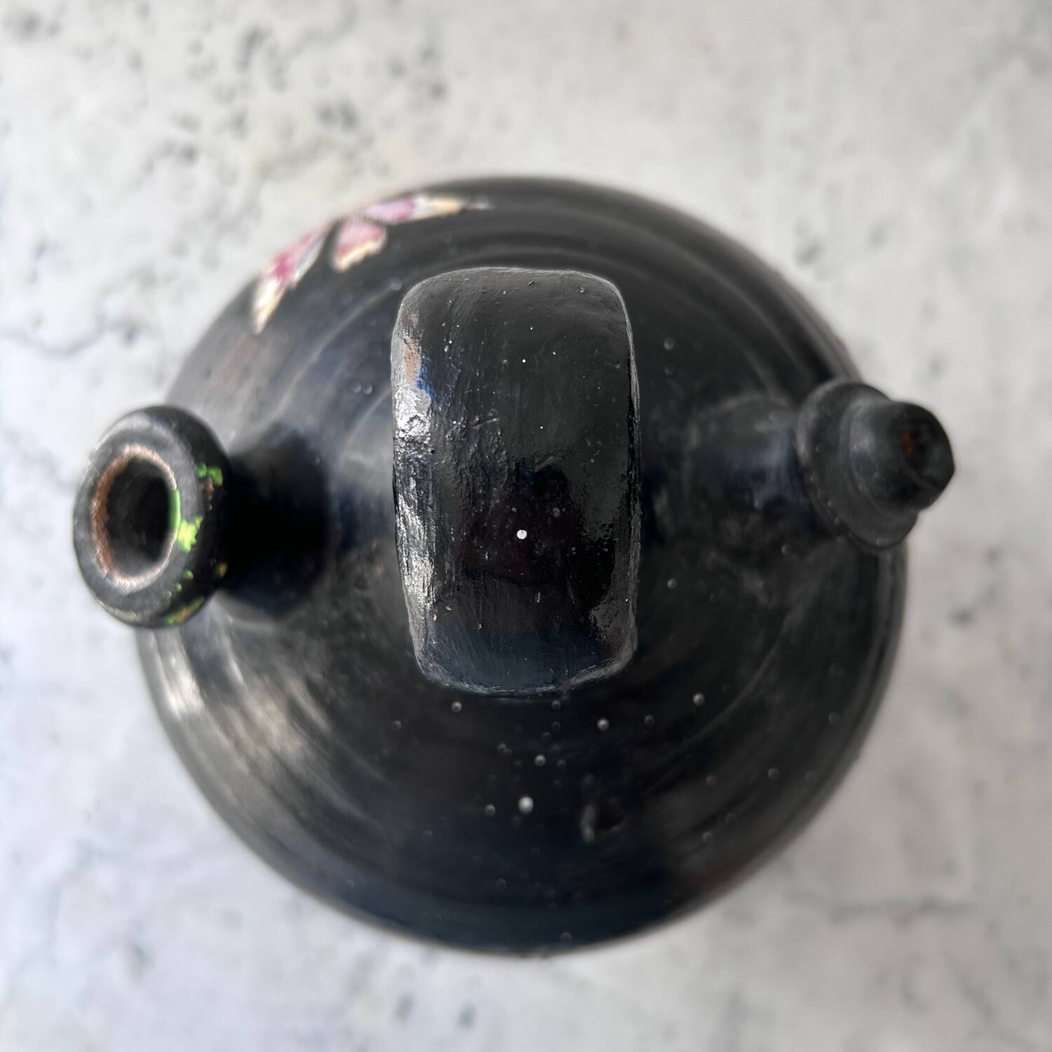 Black water jug with floral decoration