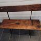 Old garden bench with iron legs and wooden seats
