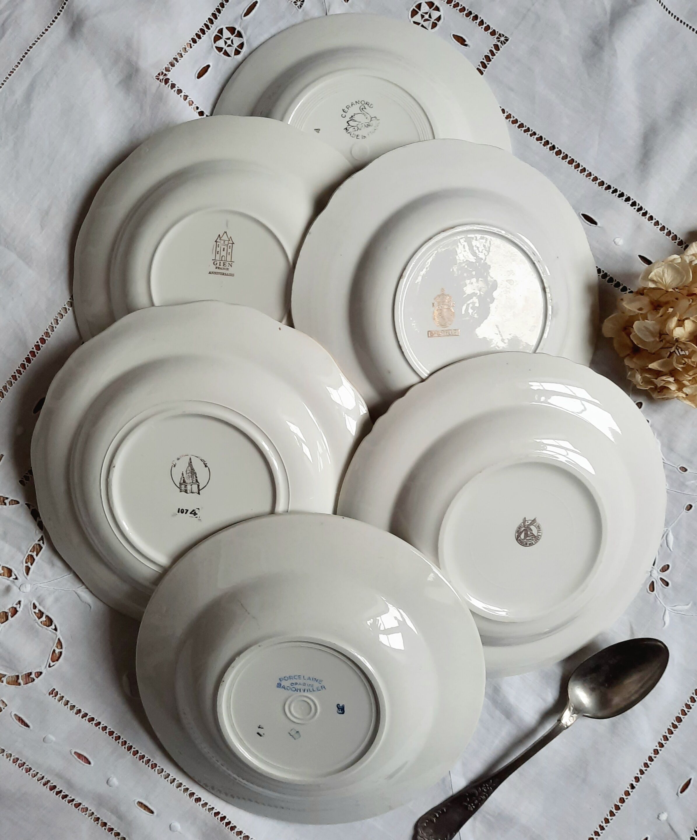 Old hollow plates mismatched in earthenware with gilded edges