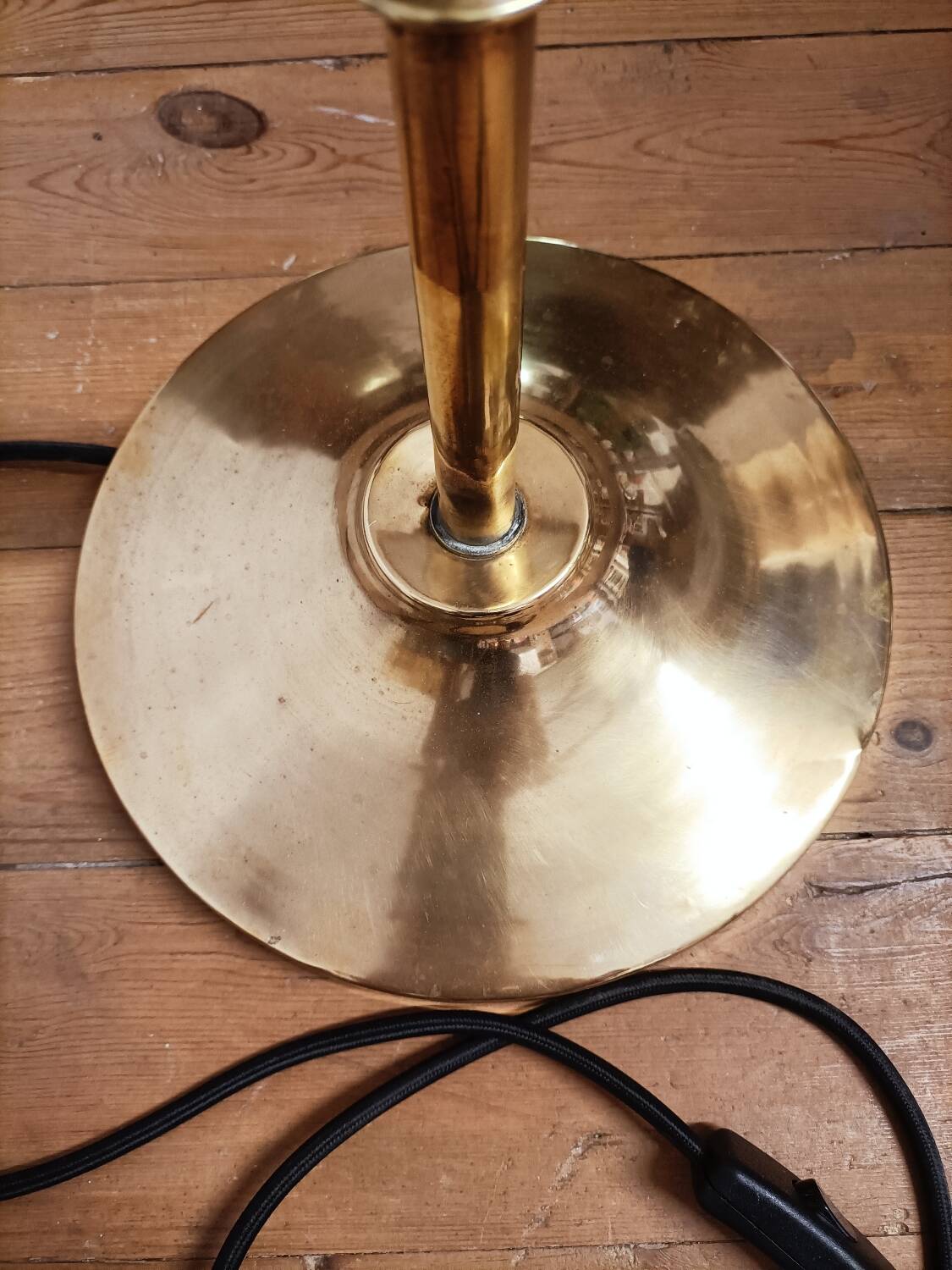 Bronze floor lamp with pine cone decoration.