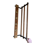 Vintage wall-mounted coat rack with five brass hooks