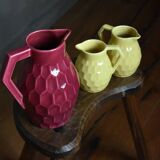 Raspberry carafe and two yellow pitchers