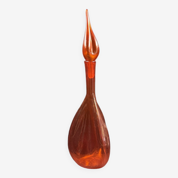 Orange bubbled glass bottle with curved body, circa 1970