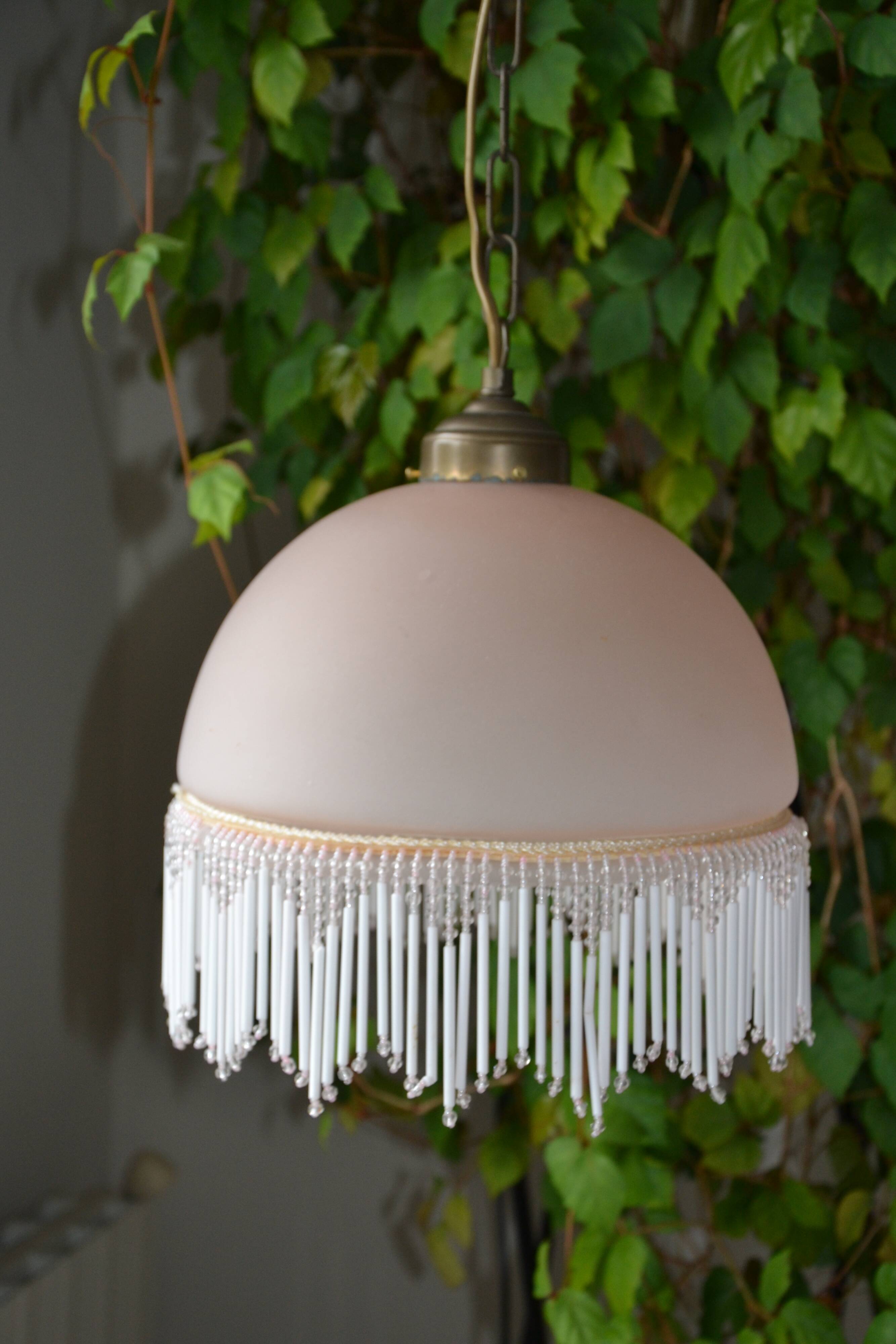 Lustrous suspension in glass paste, glass and ceramic pendants.