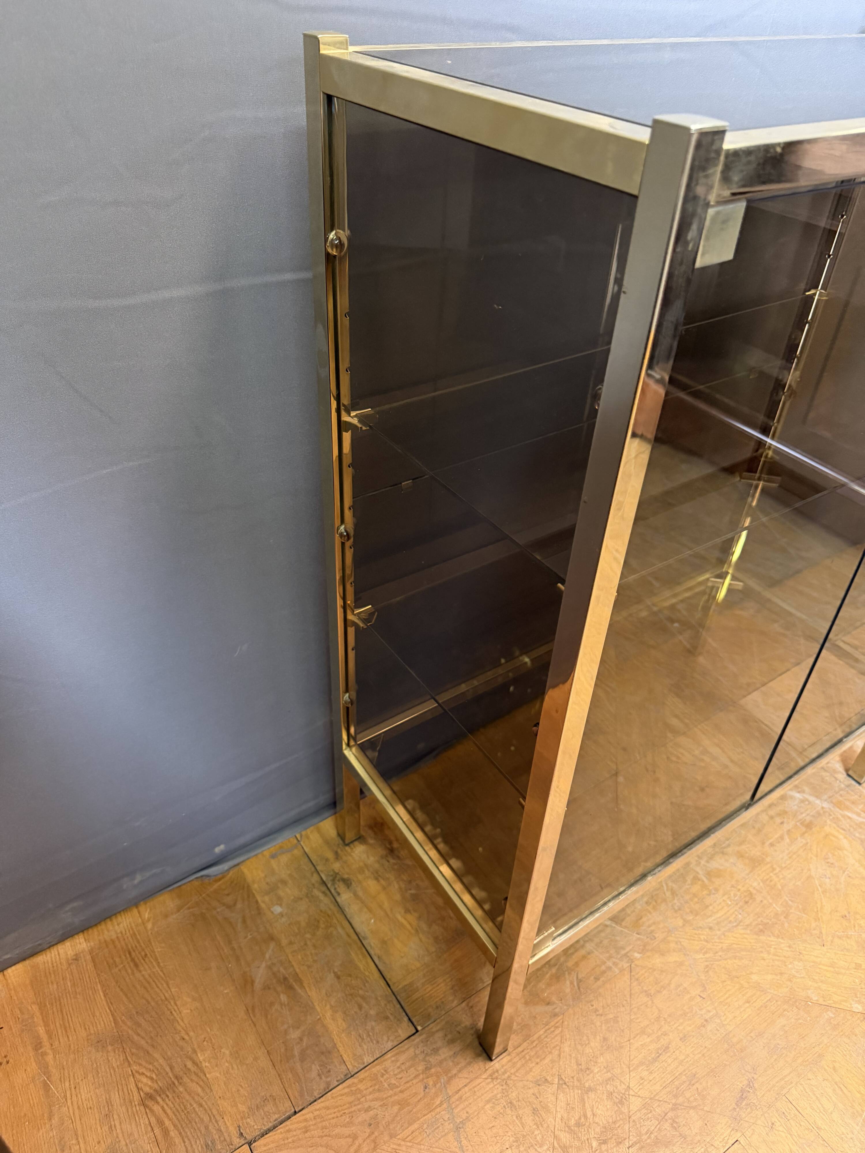 Chrome-plated brass display cabinet with smoked glass.