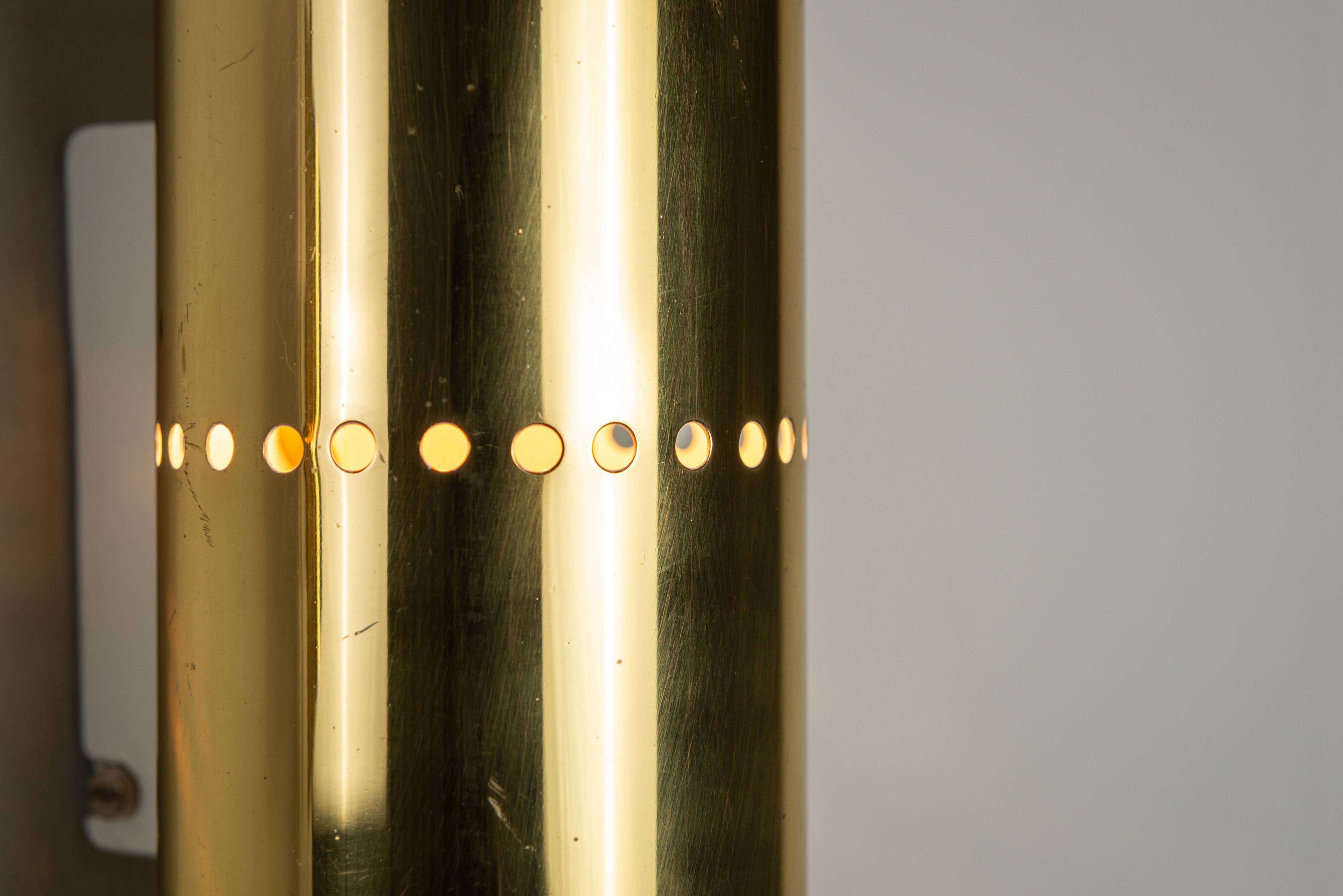 Pair of cylindrical wall lamps in brass with perforated shades