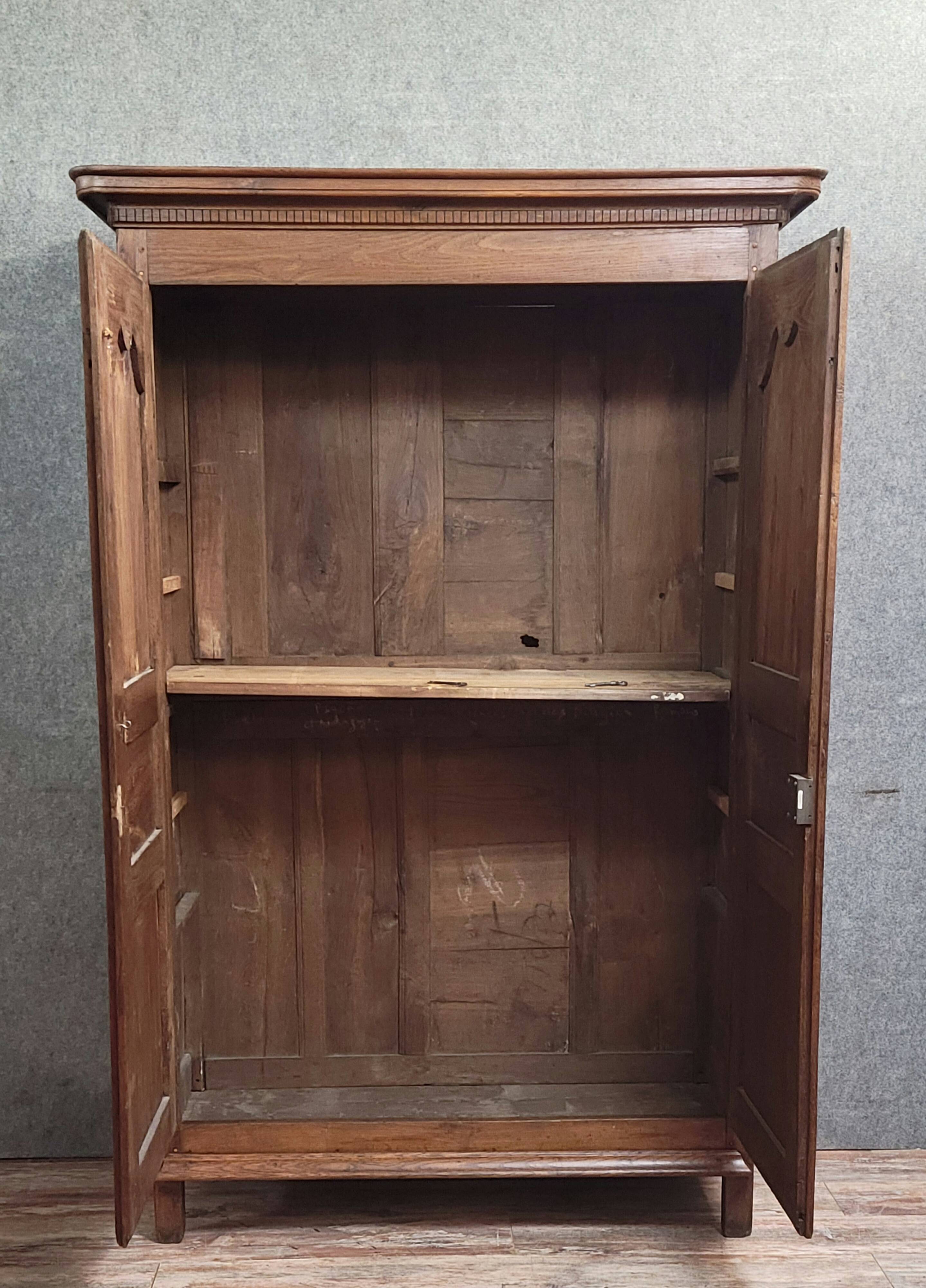 Louis XIV period wardrobe in solid oak, decorated with superb carvings