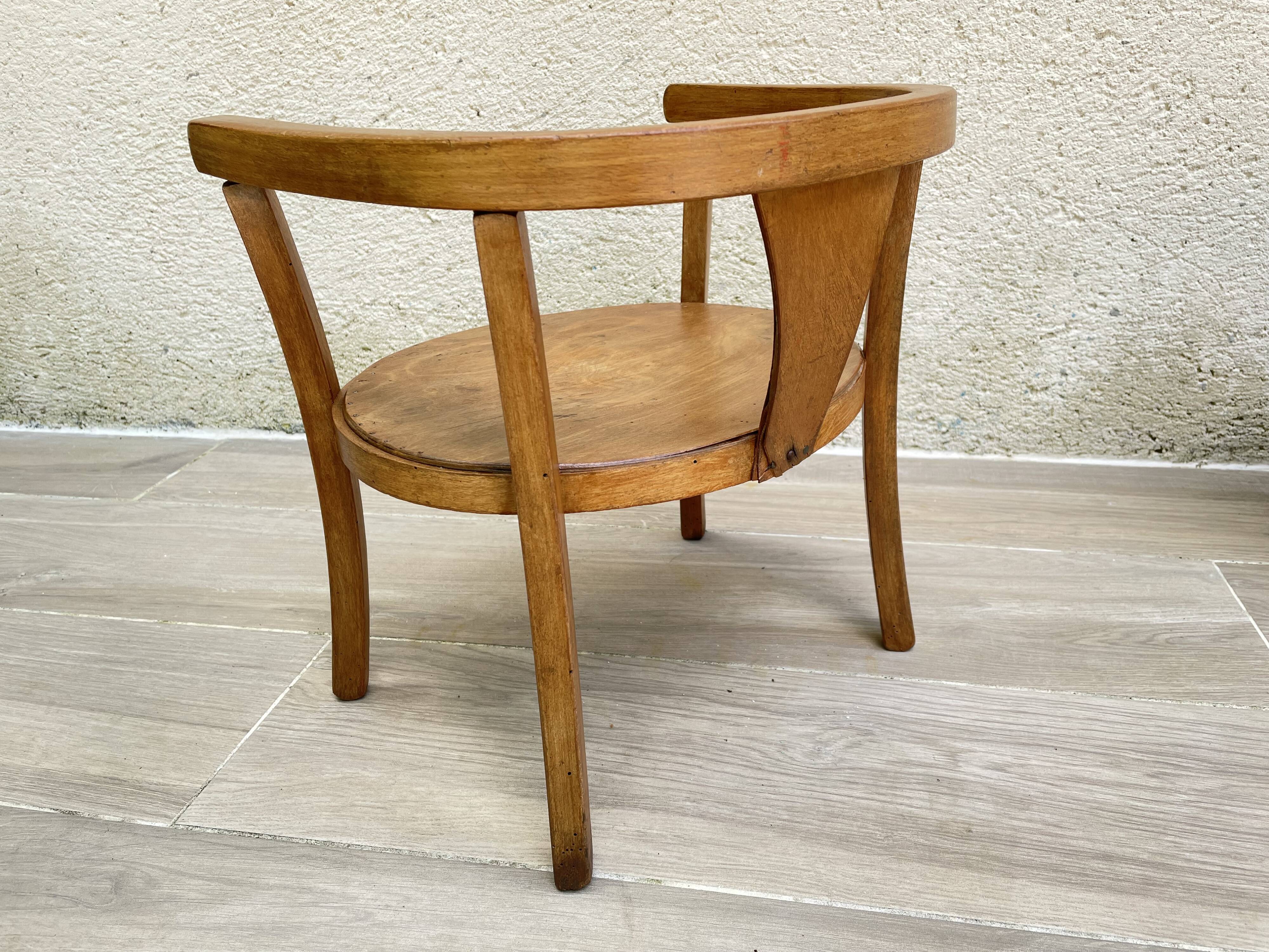 Old armchair for children in wood