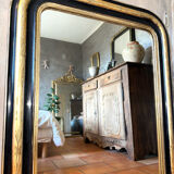 Louis-Philippe mirror in black and silver, 19th century.