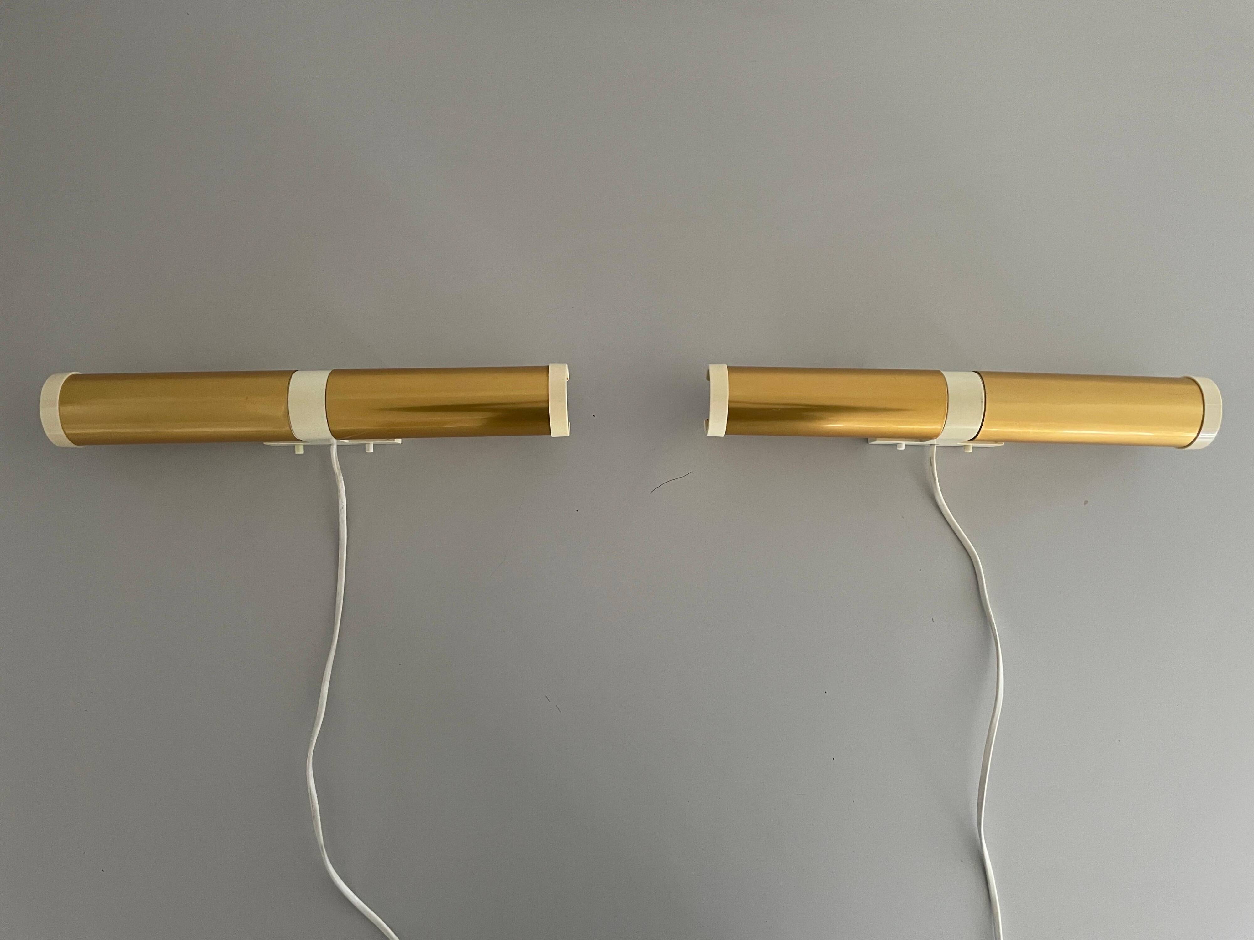 Pair of two-headed wall sconces in gold metal by ERCO, 1970s, Germany