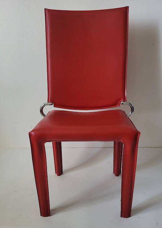 Red leather dining chairs by Arper