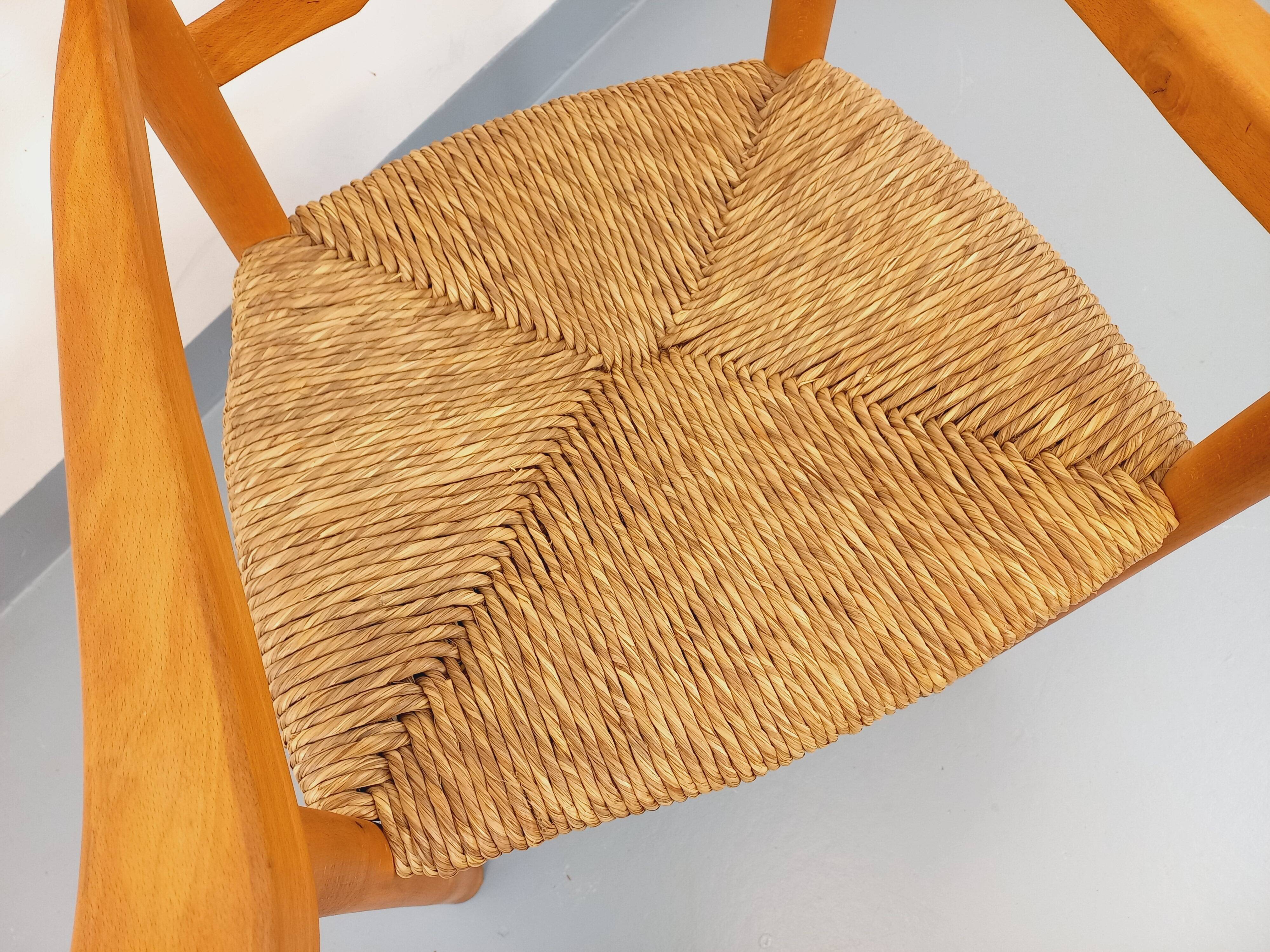 Vintage armchair in beech wood and straw from the 1950s.