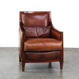 Comfortable Art Deco design armchair in cognac-colored sheepskin combined with wood