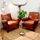 Paire de fauteuils a moustache club cuir