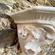 Antique wall console in patinated white plaster.