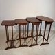 Four nesting tables with polygonal tops and decorative inlays.