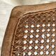 Low wooden stool with caning, footrest.