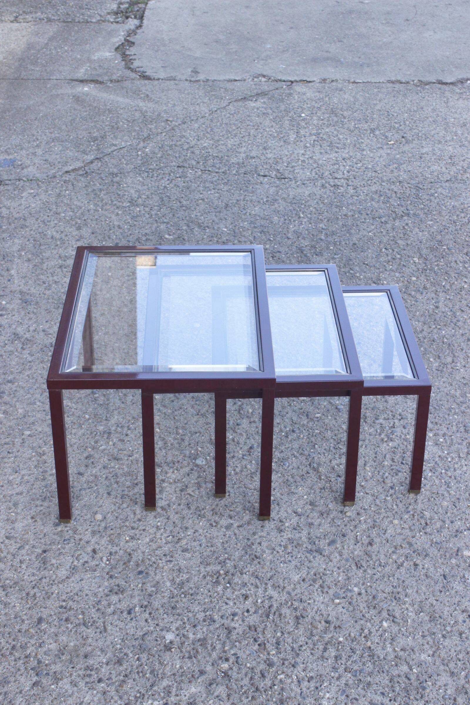 Nesting tables in burgundy lacquered metal and brass, France 1950s