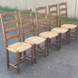 4 or 5 solid wood chairs with light oak straw and high backs