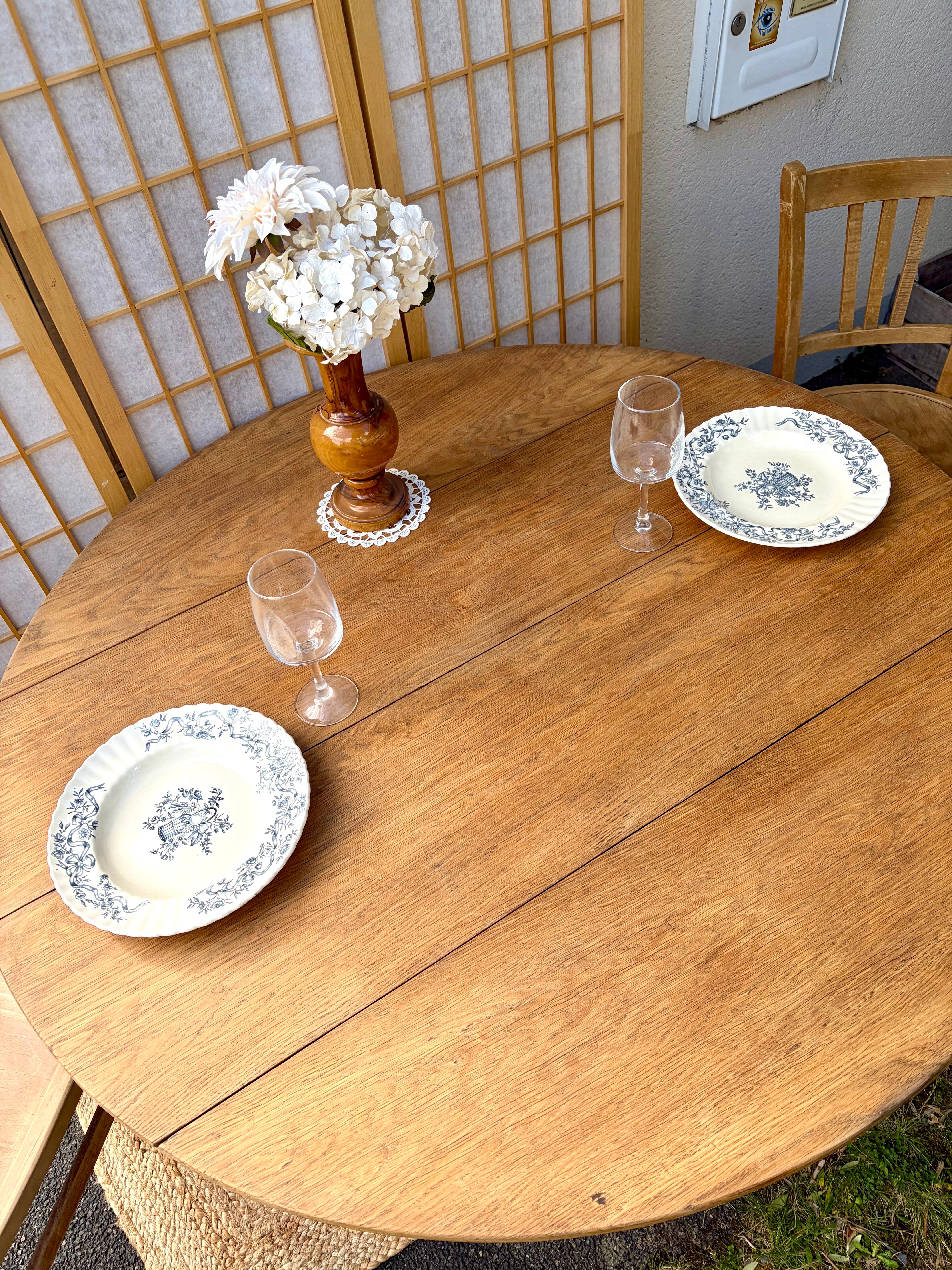 Round oak table with a drop leaf.