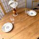 Round oak table with a drop leaf.