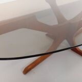 Vintage Hugues Poignant oval coffee table in teak and smoked glass from the 1970s