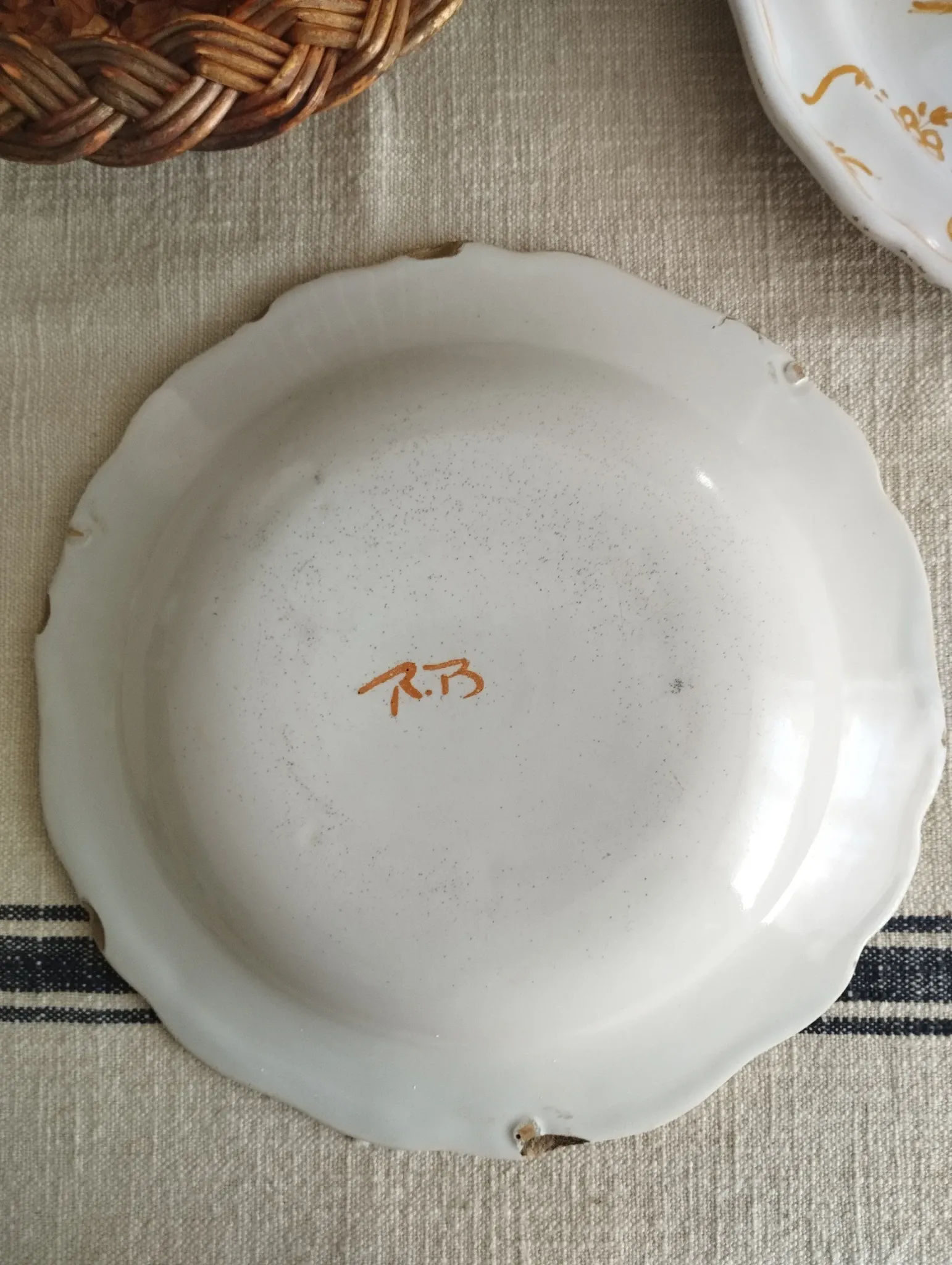 Pair of antique plates with a bird of paradise design in the style of Moustiers.