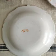 Pair of antique plates with a bird of paradise design in the style of Moustiers.
