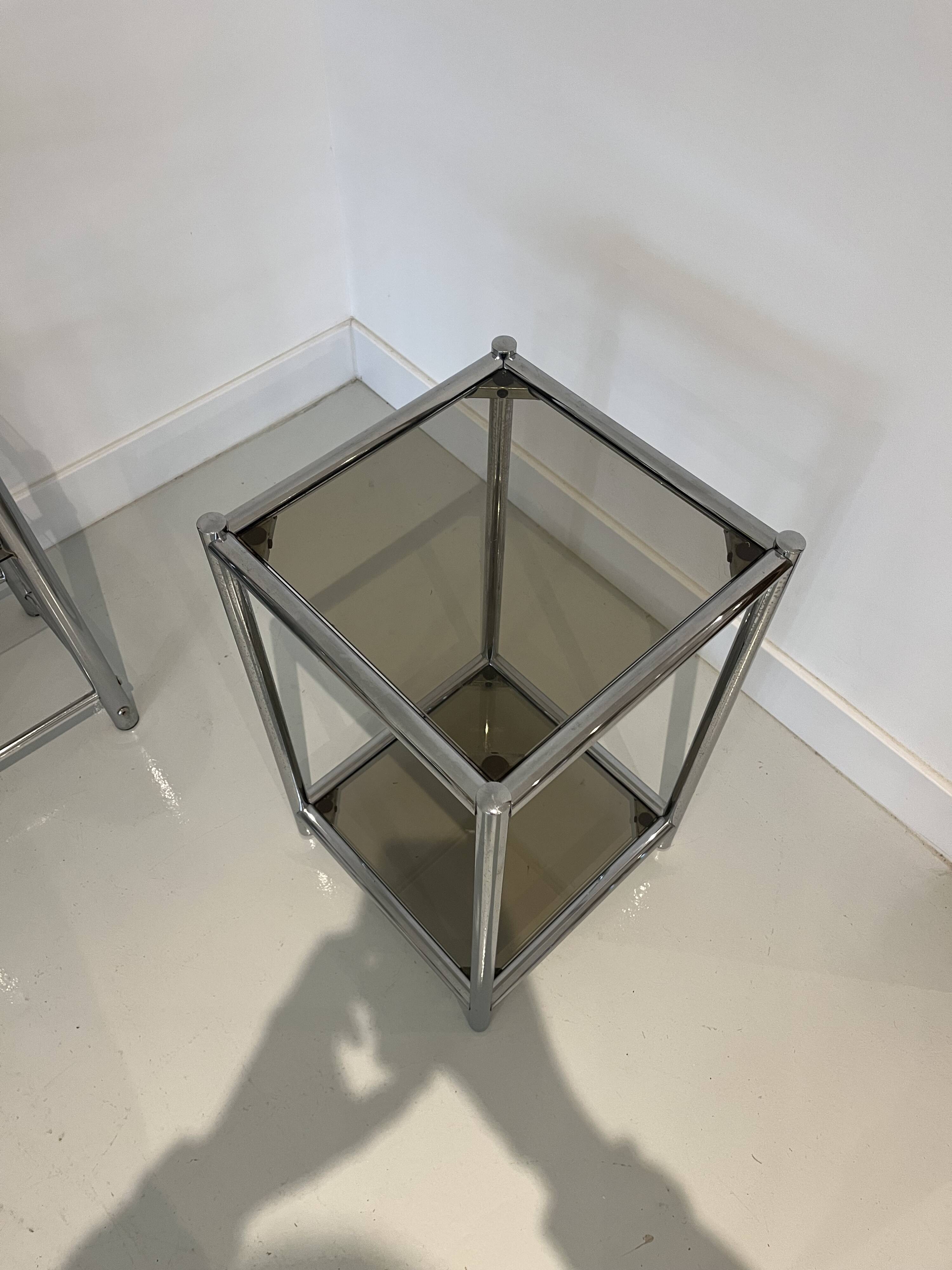 Bolster or end table in chrome steel with smoked window.