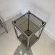 Bolster or end table in chrome steel with smoked window.