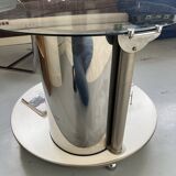 Vintage metal and smoked glass coffee table on casters bar