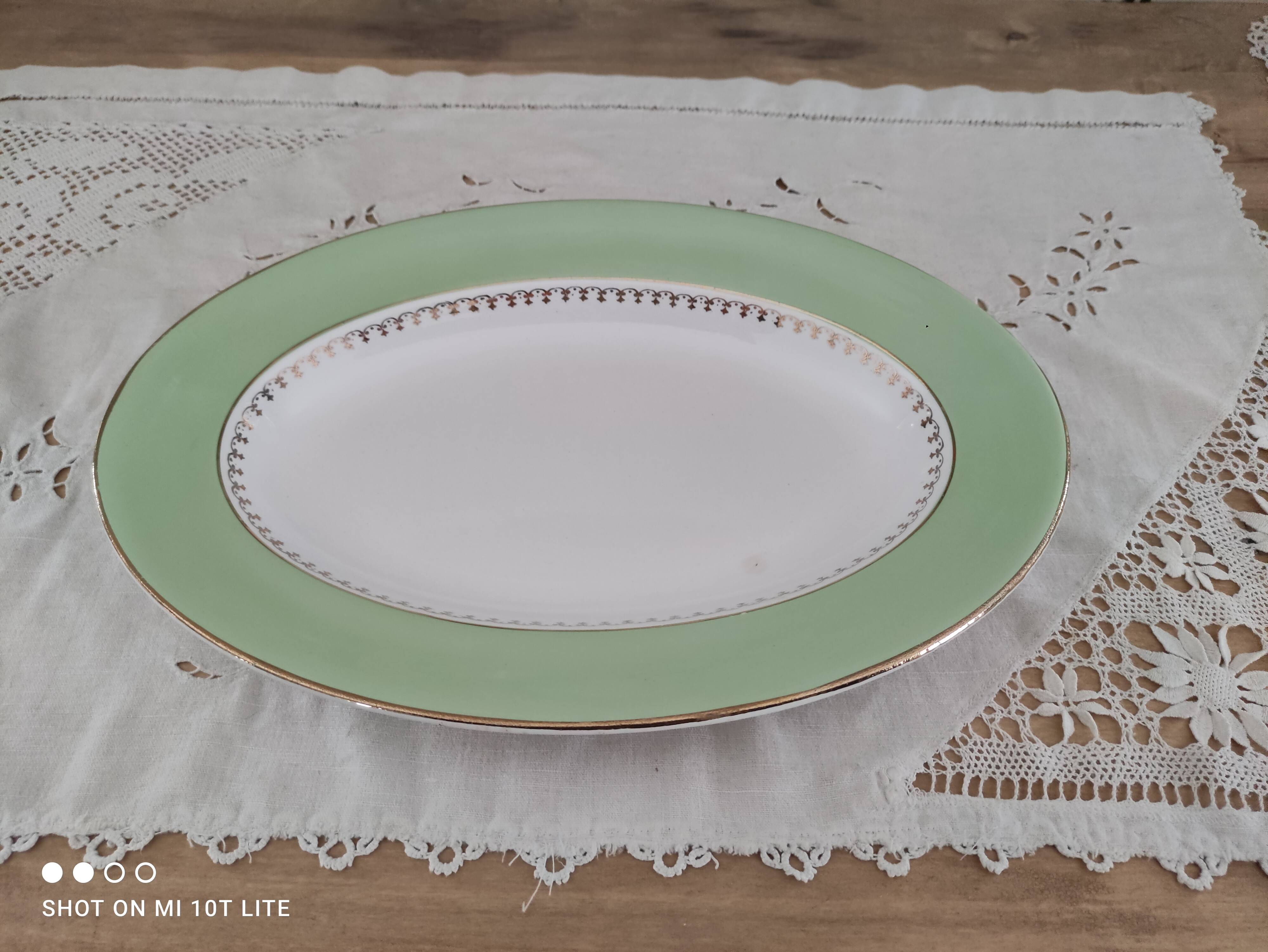 Oval plate with a light green rim and golden frieze, Cafés Lemaire.