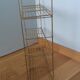 String shelf in golden metal wires