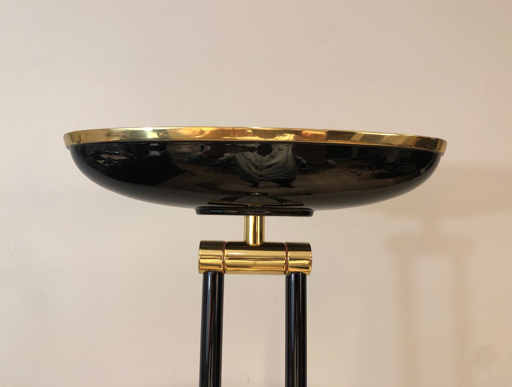 Black lacquered metal floor lamp with brass.