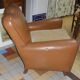 Brown leather club armchair