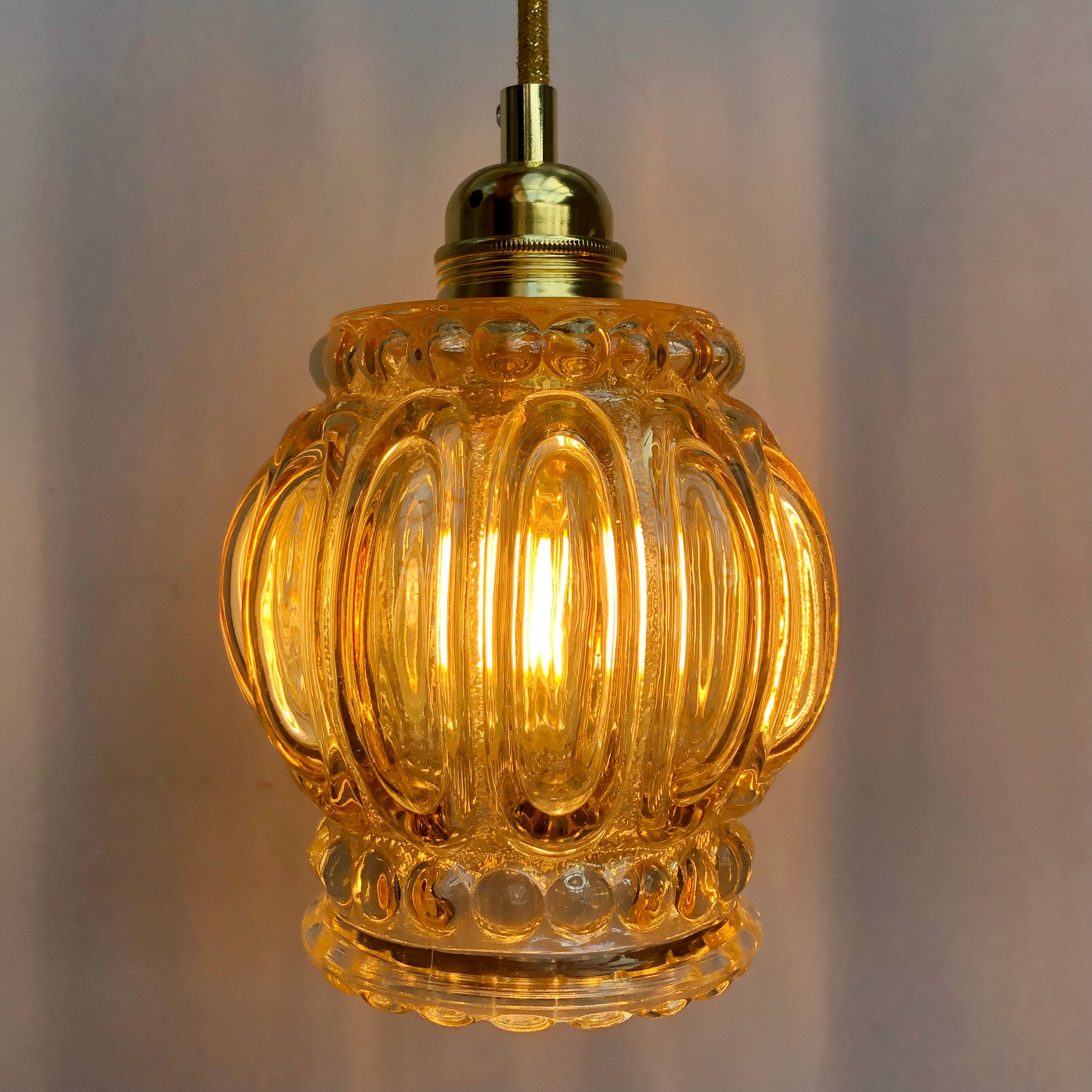 Vintage amber glass globe hand lamp